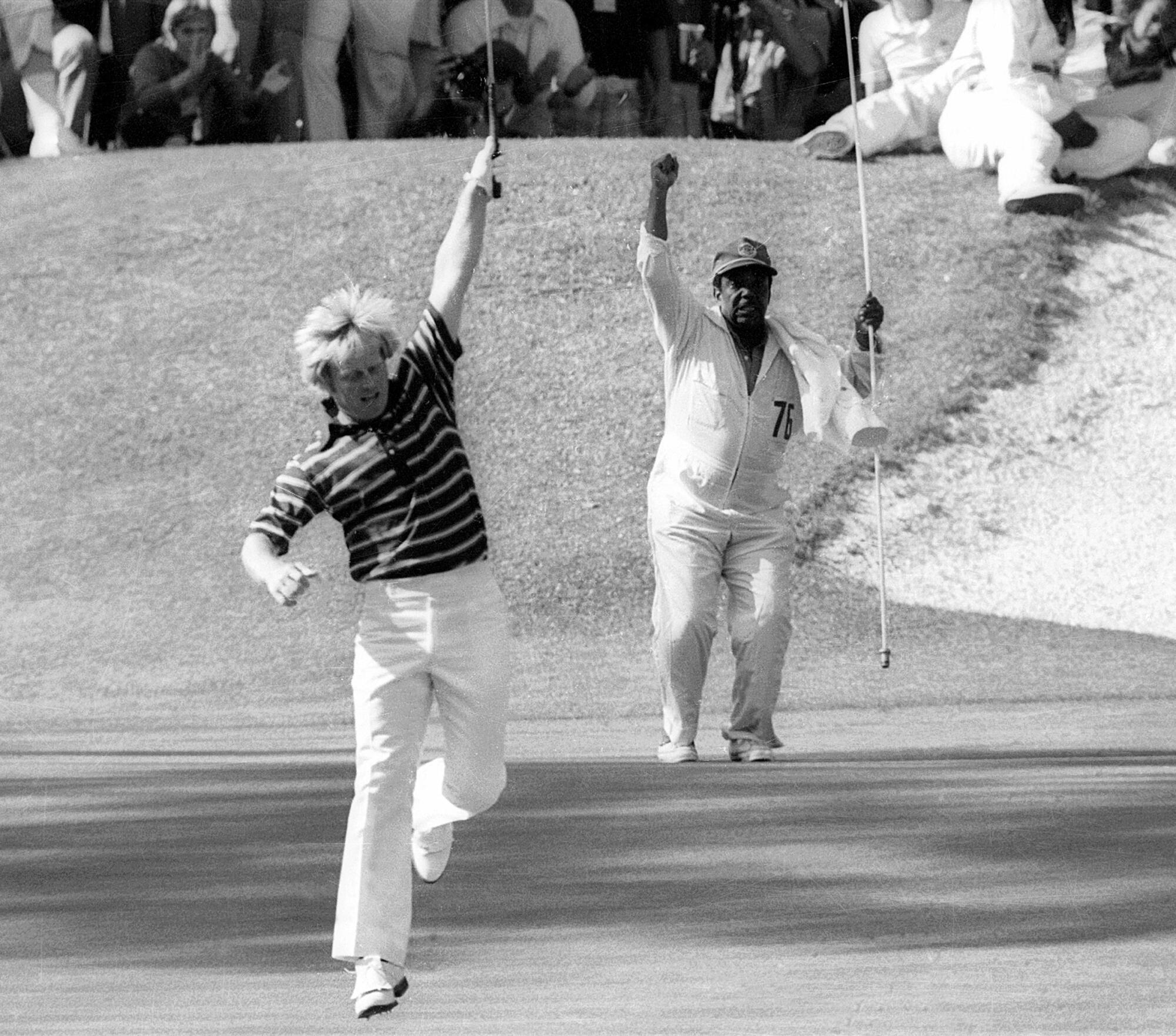  Jack Nicklaus and his caddie, Willie Peterson, celebrate a birdie putt on the 16th hole.