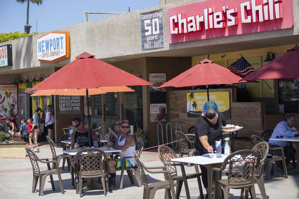 Patrons eat lunch at Charlie's Chili near the Newport Beach Pier on May 27.