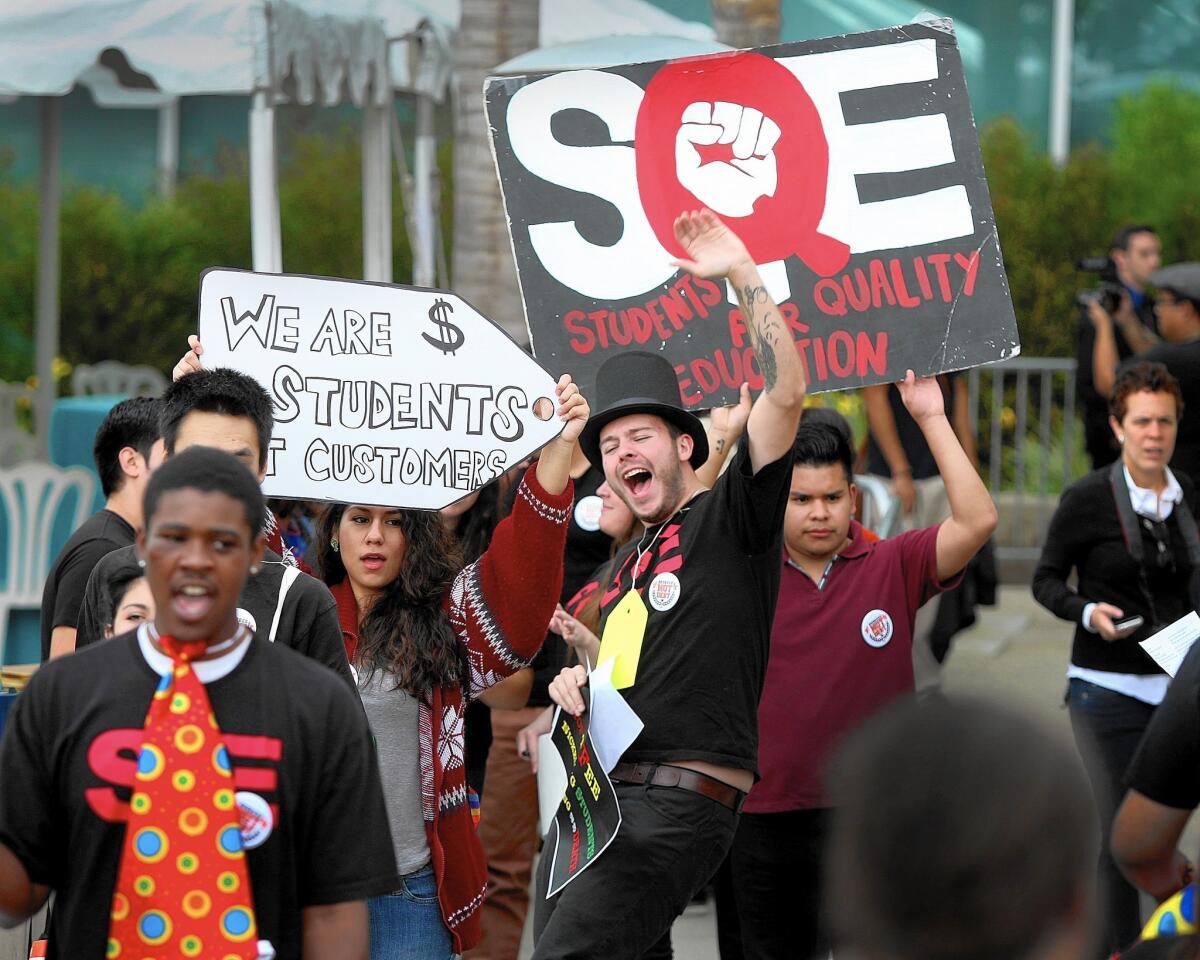 Cal State Dominguez Hills student Robert DeWitz, center, leads student protesters in a chant against campus fees outside the Cal State trustees' meeting in Long Beach.