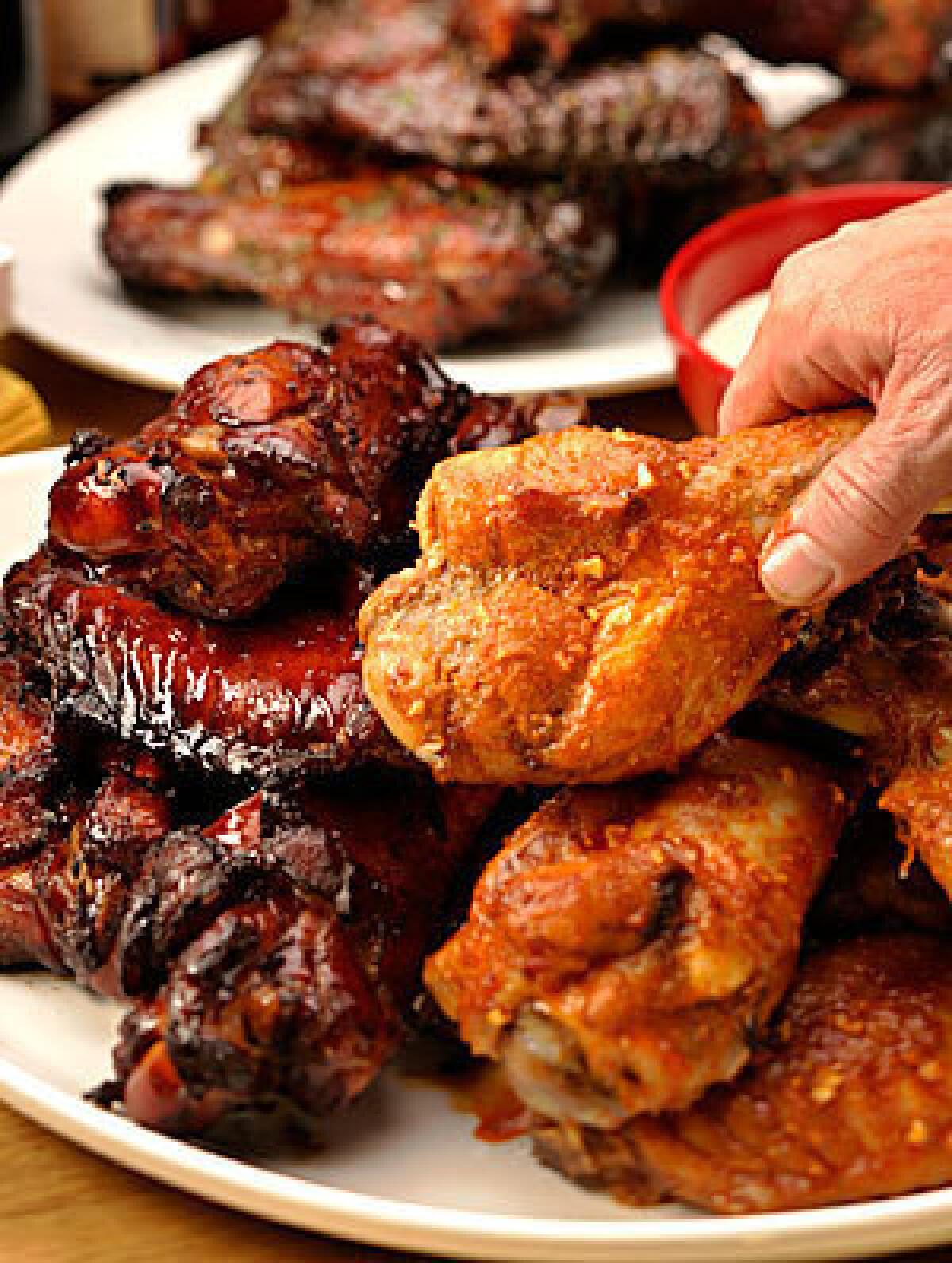 OH, YEAH! Get started with this trio: teriyaki bourbon, left, spicy barbecue and honey wings.