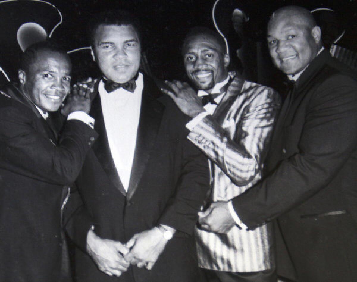 Among the celebrities Bill Jones photographed during his long career was boxing champion Muhammad Ali, second from left. A fundraiser plananed for Nov. 29 at Spago in Beverly Hills will help pay for future surgery that the 78-year-old Jones requires because of a 1997 attack, organizers say.