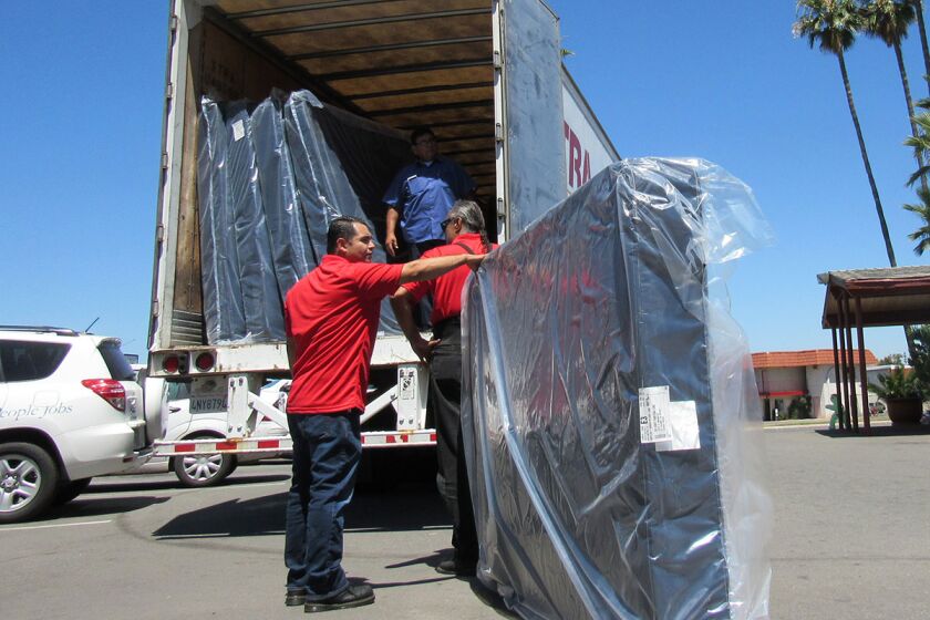 June 16, 2017_El Cajon_ California_USA_ Employees of Jerome's Furniture deliver 60 mattresses to the East County Transitional Living Center on Friday. From left to right are Rigo Contreras, Julio Reynoso (in truck) and Gabriel Palos de Larosa ._Mandatory Photo Credit: Photo by Karen Pearlman/San Diego Union-Tribune_© 2017 San Diego Union-Tribune, LLC