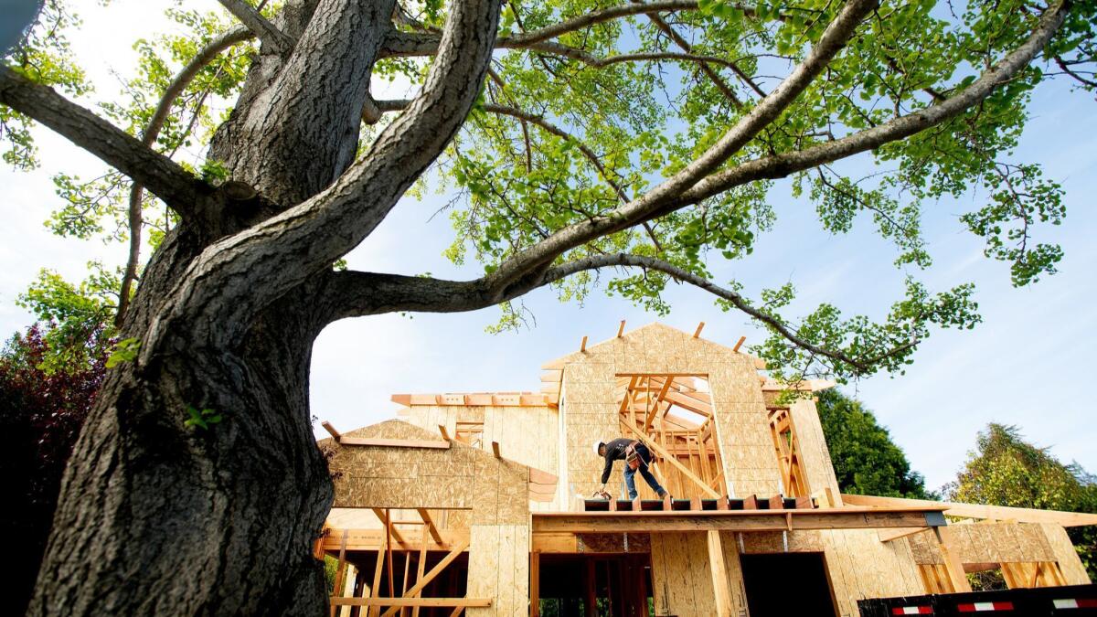 A construction worker builds a single-family home in Palo Alto. The median price of an existing home has soared to $1.2 million in Silicon Valley, the highest of any market in the country.