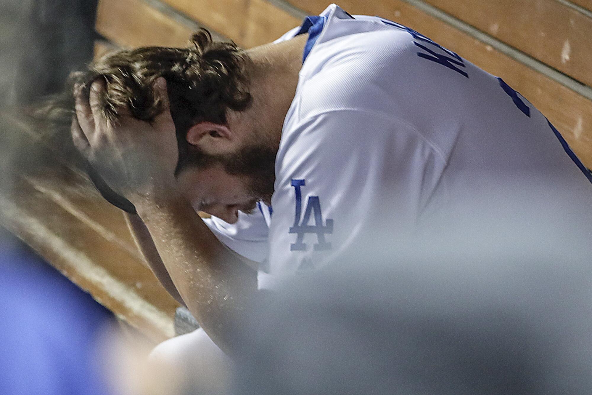 Clayton Kershaw in the dugout after giving up consecutive homers in the 8th inning in game 5 of the National League Division Series at Dodger Stadium.
