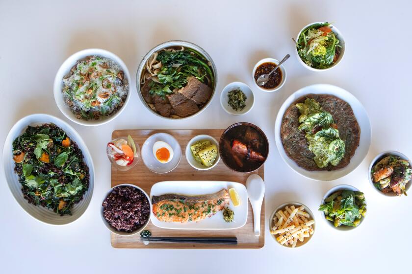 Photographs by Mel Melcon??Los Angeles Times Two-year-old Theodore Beteta, top right, tries the salmon rice. The beef noodle soup, top left, and assorted dishes and sides at Yang’s illustrate its modern fusion food.