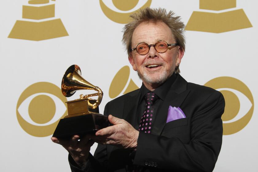 Paul Williams, a collaborator on Daft Punk's album "Random Access Memories," shows off his Grammy for album of the year.