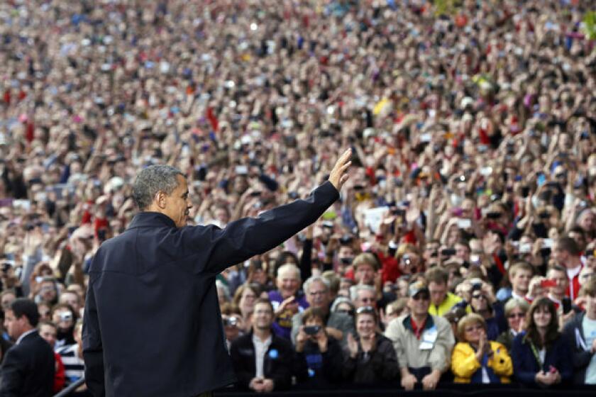 President Obama waves to supporters as he takes the stage during a campaign event at the University of Wisconsin-Madison.