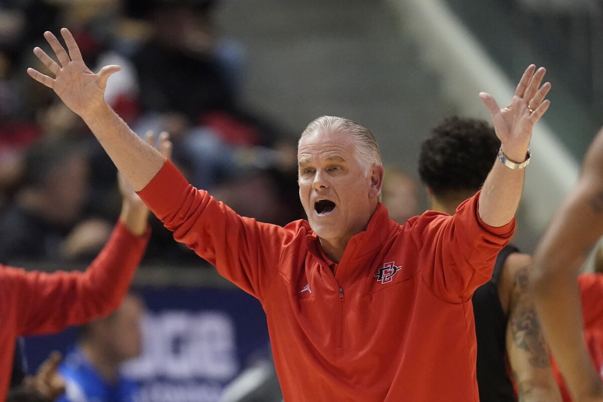 FILE - San Diego State coach Brian Dutcher reacts after a call during the first half of the team's NCAA college basketball game against BYU on Nov. 12, 2021, in Provo, Utah. Three decades after Brian Dutcher was the lead recruiter who signed Juwan Howard at Michigan, the two will oppose each other as coaches on Saturday. Dutcher brings his San Diego State team into Ann Arbor to face the Wolverines, who are in their third year under Howard, who was the first of the fabled Fab Five to sign with Michigan. (AP Photo/Rick Bowmer, File)