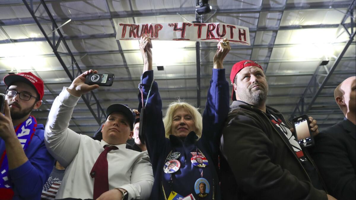 Supporters listen to President Donald Trump speak at a rally on April 28 in Washington, Mich.