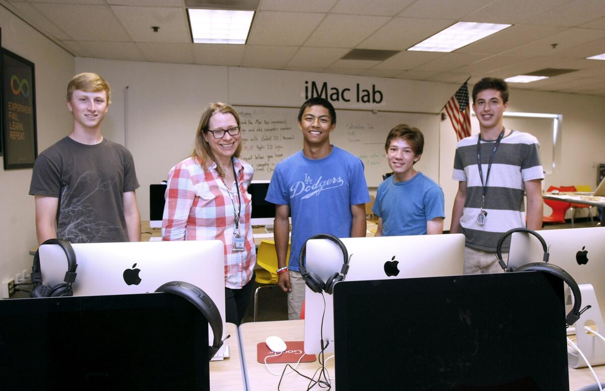 Some members of the La Cañada High School iTeam club include, left to right, Clay Massimino, adviser Jamie Lewsadder, Matthew Pasion, Braden Oh and club president Jonathan Connelly, at the iMac lab on campus on Tuesday, April 14, 2014.