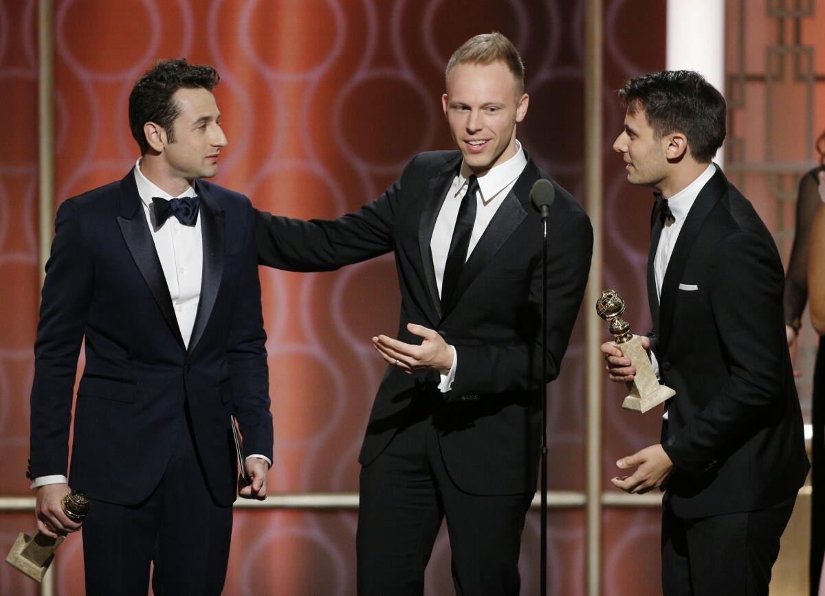 From left to right, Justin Hurwitz, Benj Pasek and Justin Paul accept the award for original song for "City of Stars" from "La La Land" during the 74th Golden Globe Awards on Jan. 8, 2017.