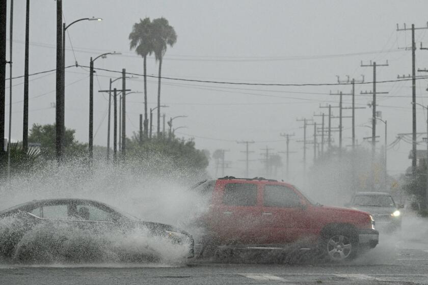 Vehicles splash up water during heavy rains from Hurricane Hilary, in south Los Angeles, California, on August 20, 2023. Hurricane Hilary weakened to a tropical storm on August 20, 2023, as it barreled up Mexico's Pacific coast, but was still likely to bring life-threatening flooding to the typically arid southwestern United States, forecasters said. Authorities reported at least one fatality in northwestern Mexico, where Hilary lashed the Baja California Peninsula with heavy rain and strong winds. (Photo by Robyn BECK / AFP) (Photo by ROBYN BECK/AFP via Getty Images)