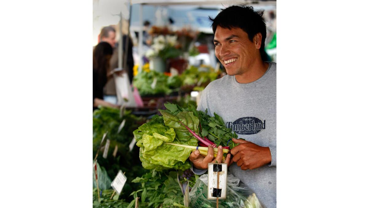 Romeo Coleman of Carpinteria mans the Wednesday Coleman Family Farm stand. He is taking over from his dad, Bill Coleman.