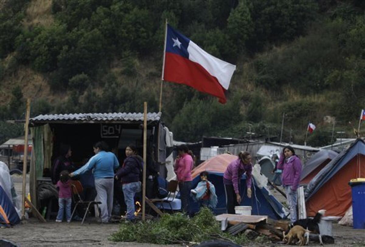 A Chilean flag flies at a camp for earthquake survivors in Concepcion, Chile, Sunday, March 7, 2010. An 8.8-magnitude earthquake struck central Chile on Feb. 27, causing widespread damage. (AP Photo/Aliosha Marquez)