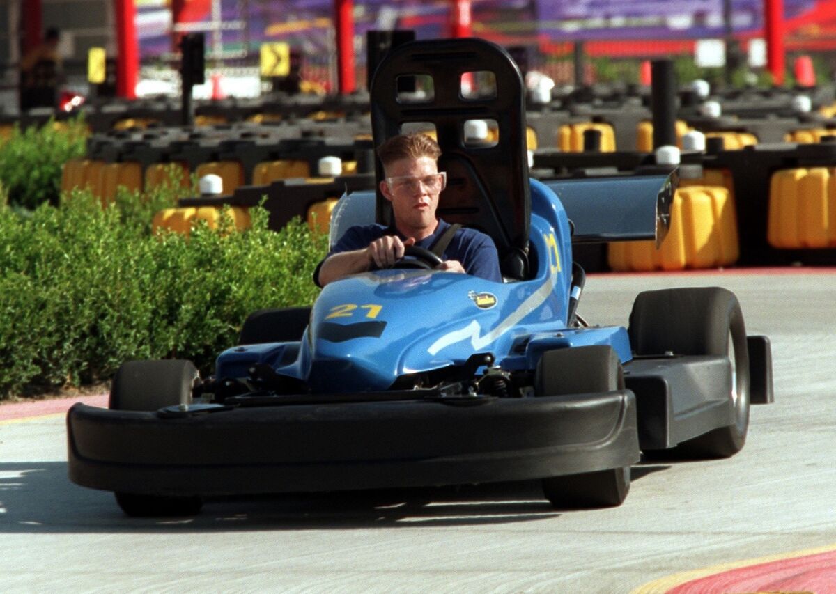 A man races a car at SpeedZone in the City of Industry. The facility is one of 14 family centers that Palace Entertainment has sold to Apex Parks Group.