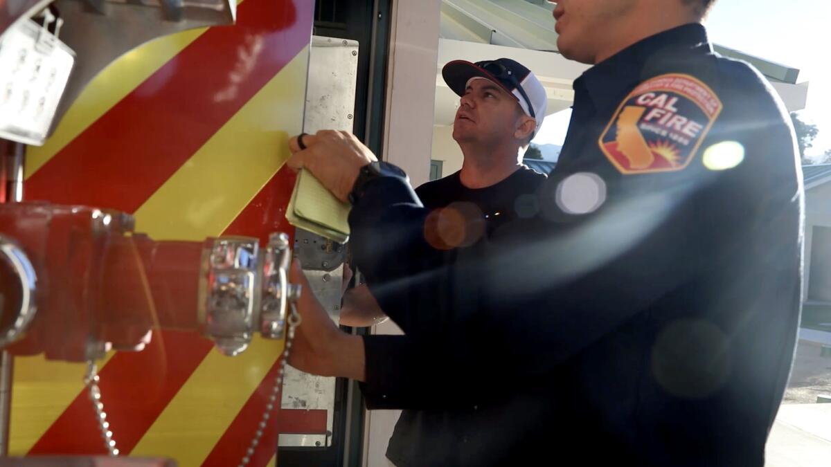 Cal Fire firefighter Jason McMillan, left, returns to work in San Diego after a trauma retreat. McMillan fought fires alongside Capt. Ryan Mitchell, who died by suicide in 2017.