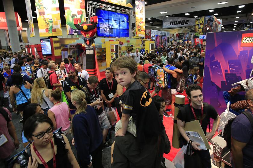 Zak Skelly rides on his father's shoulders through a packed San Diego Convention Center at Comic-Con International on July 23, 2014. The convention will remain in San Diego through 2018.