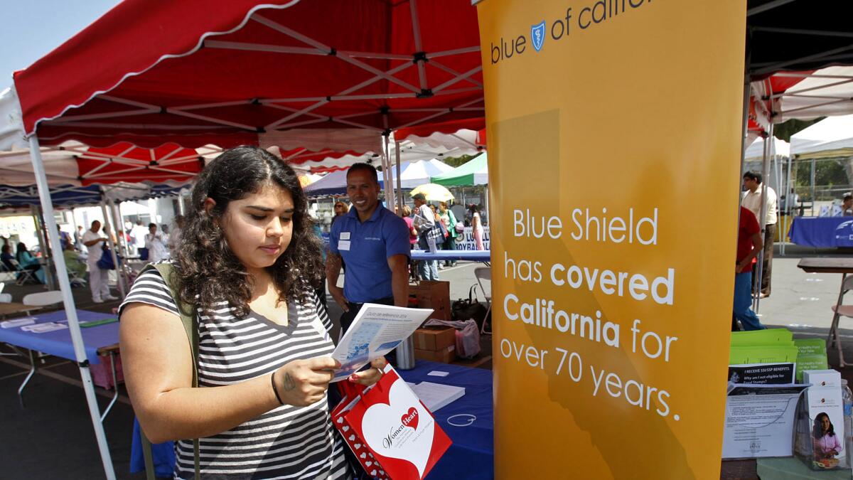 Blue Shield of California's premiums are drawing renewed scrutiny since the California Franchise Tax Board stripped the insurer of its longtime exemption for state income taxes after an audit. Above, Sophia Bracho, 20, gets info from the Blue Shield booth at the East L.A. Health Fair in 2013.