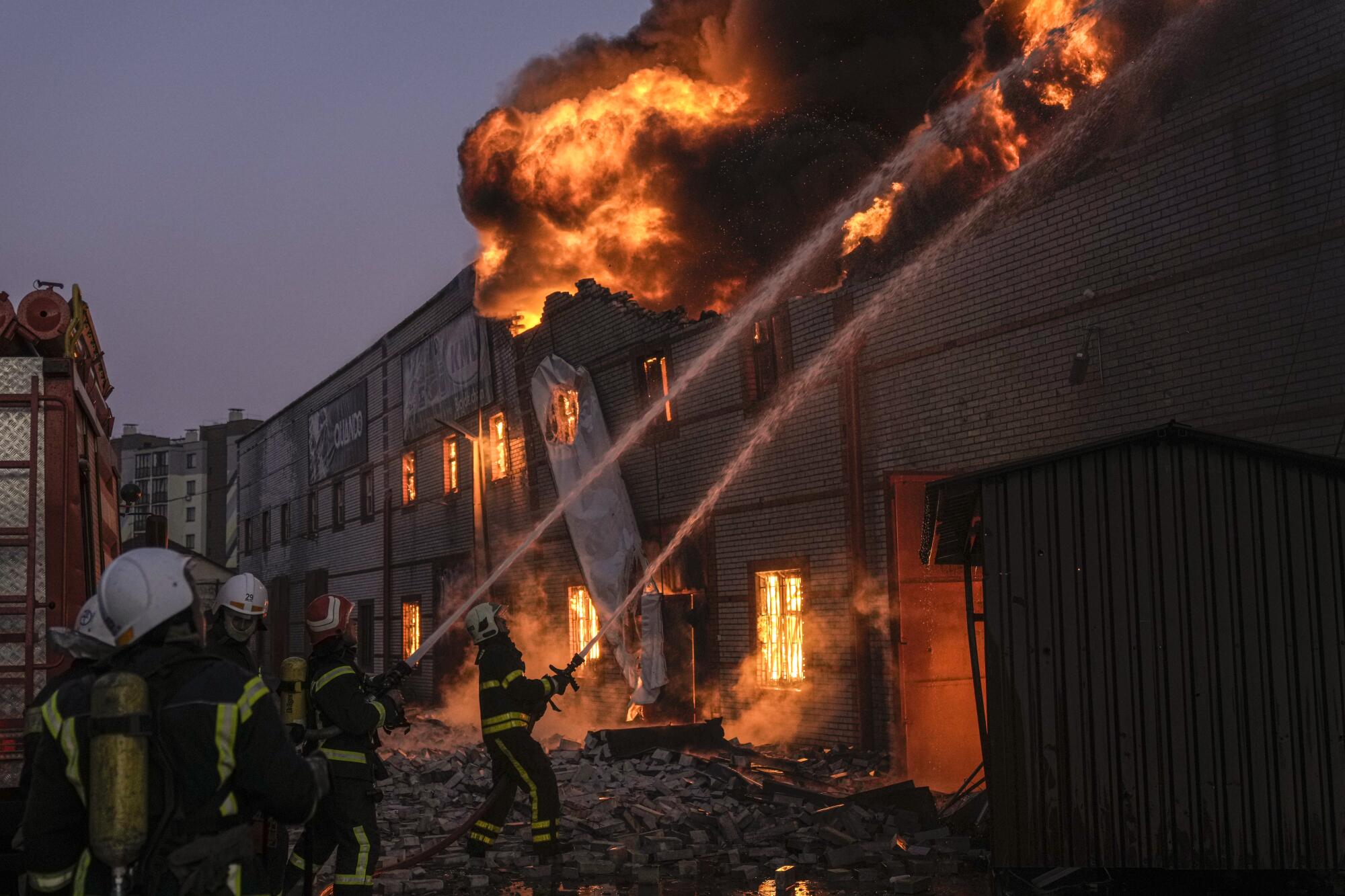 Firefighters battle a blaze at a warehouse after a bombing in Kyiv, Ukraine, on Thursday. 