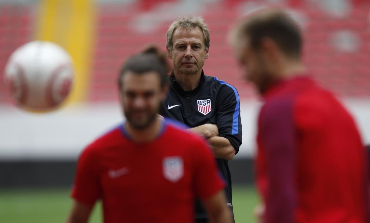United States Coach Juergen Klinsmann watches as players practice.