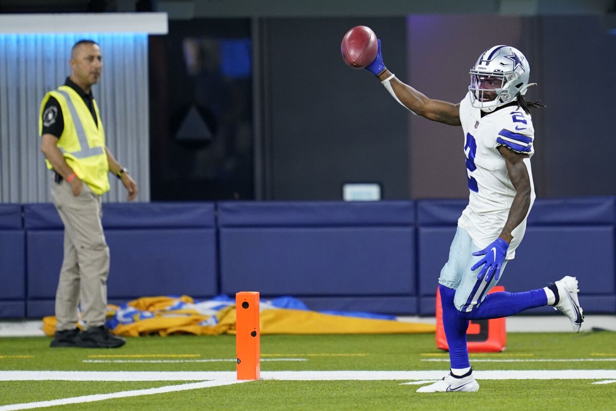 Dallas Cowboys' KaVontae Turpin celebrates as he returns a punt for a touchdown during the first half of a preseason NFL football game against the Los Angeles Chargers Saturday, Aug. 20, 2022, in Inglewood, Calif. (AP Photo/Ashley Landis)