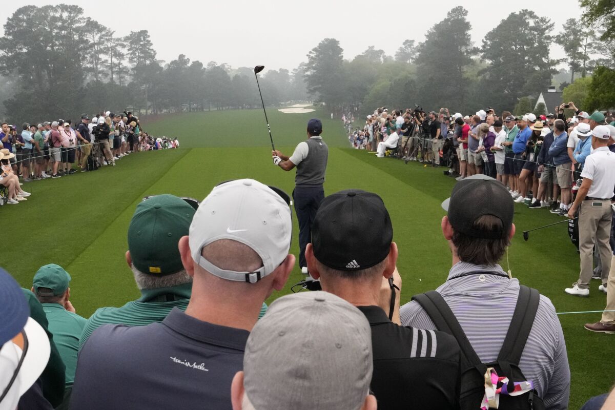 Tiger Woods tees off the first tee during practice for the Masters golf tournament. 