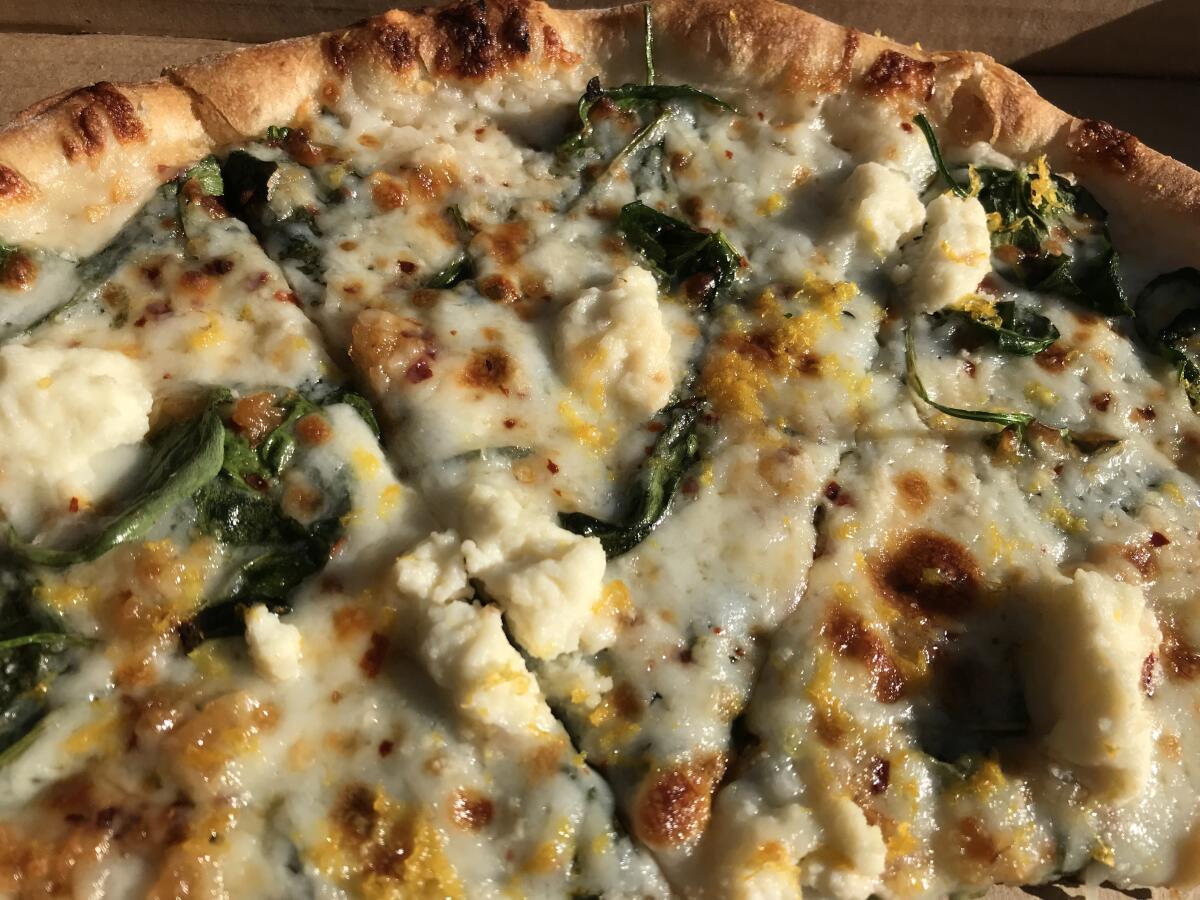 Bird Rock's Wheat & Water's wood-fired spinach and ricotta pizza gets an unexpected, and delicious, kick from lemon zest.