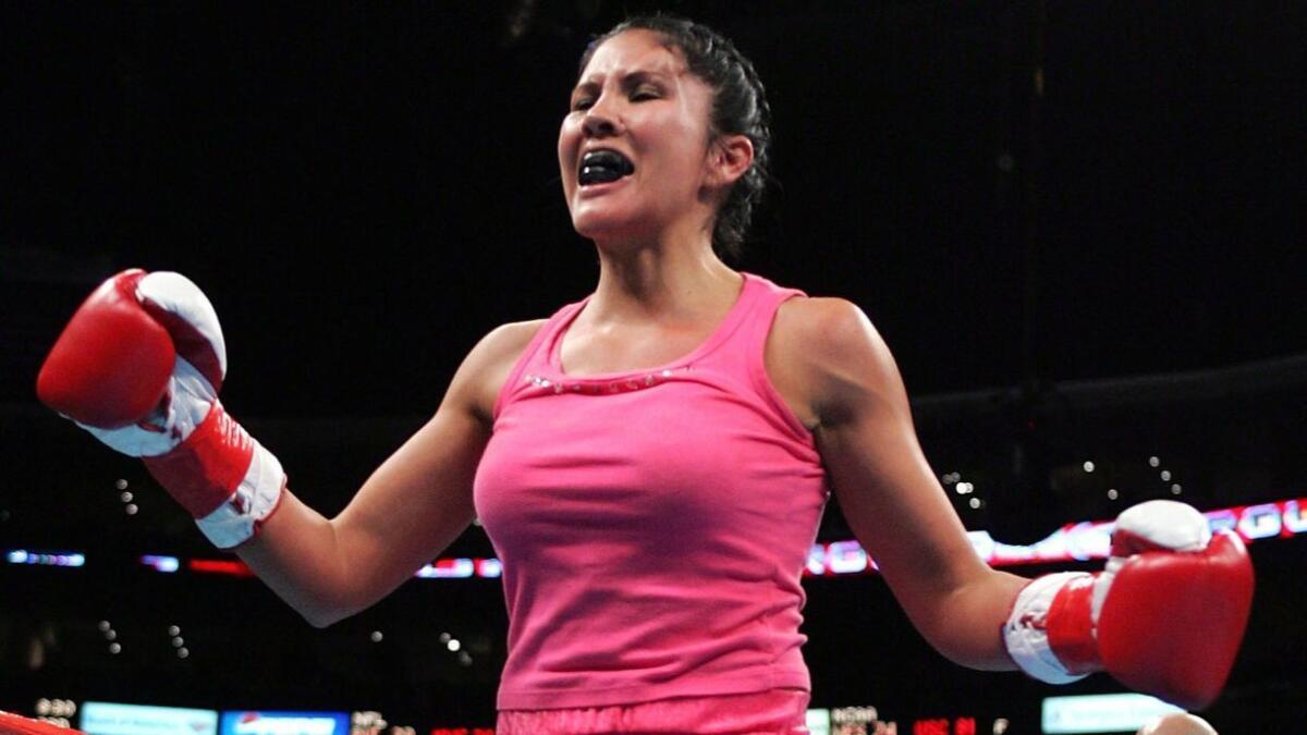 Mia St. John celebrates after defeating Janae Romero Archuleta on Dec. 18, 2004 at Staples Center.