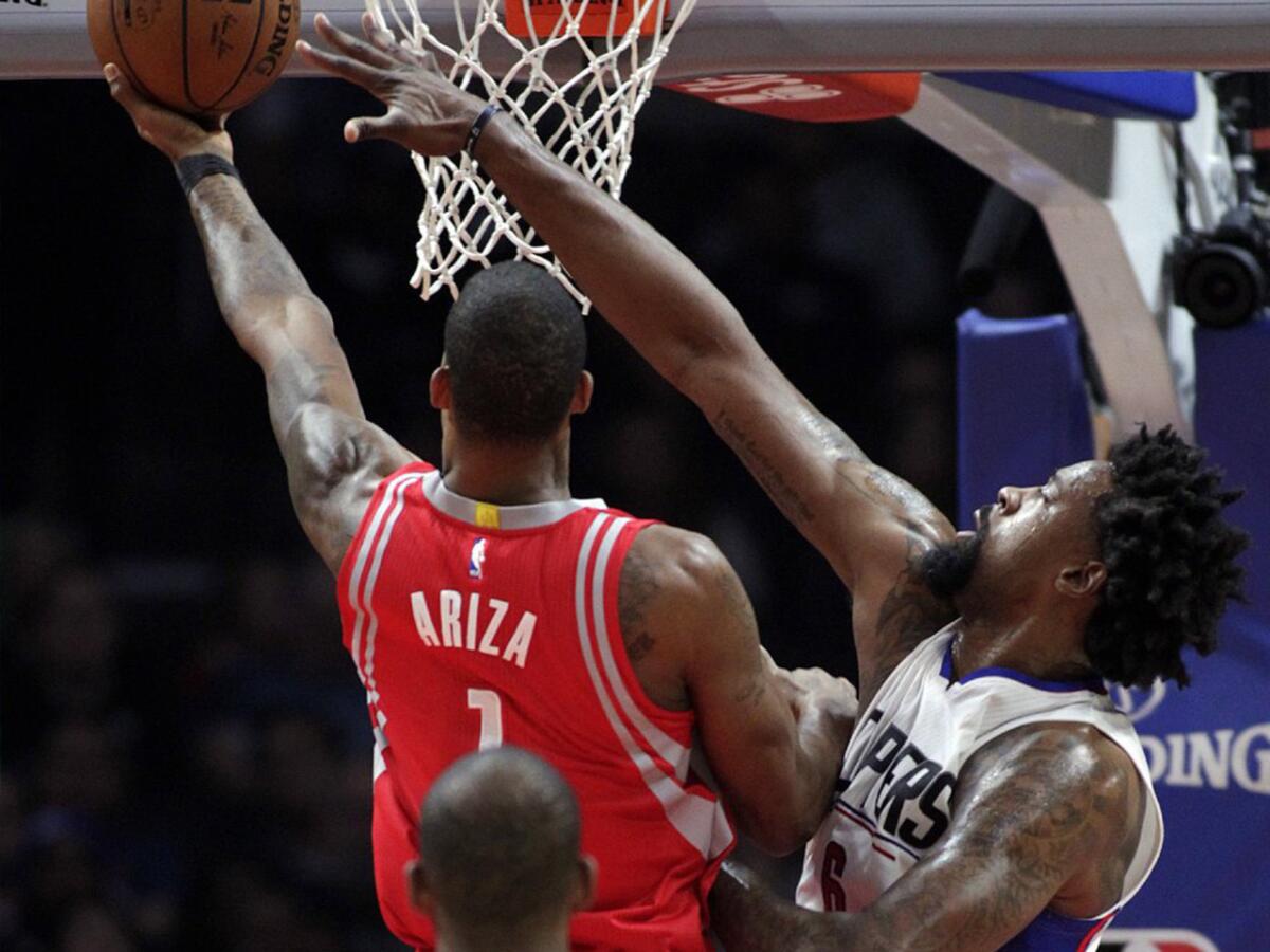 Clippers center DeAndre Jordan defends the basket against Rockets forward Trevor Ariza during a game at Staples Center on Jan. 18.