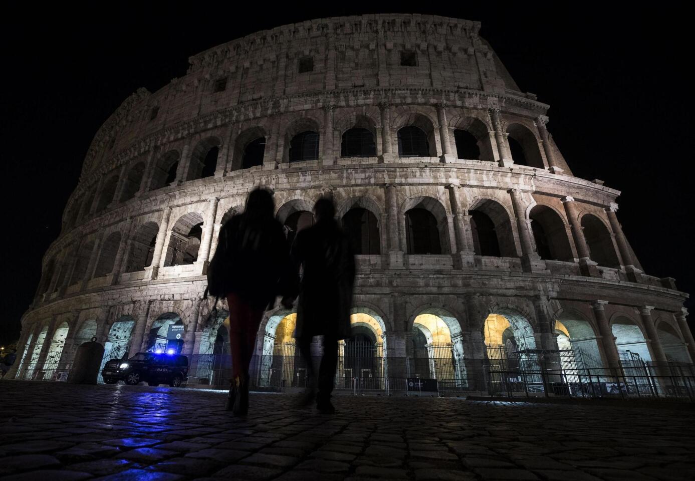 The lights are off at the ancient Colosseum in Rome on May 23, 2017, in tribute to the victims of the terrorist attack in Manchester, England.
