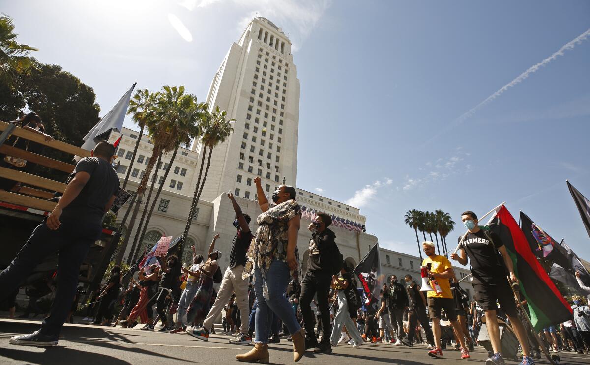 A crowd marched past L.A. City Hall following a Black Lives Matter rally on the first anniversary of George Floyd's death.