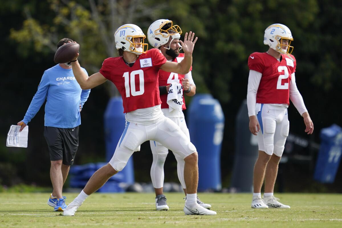 Chargers quarterback Justin Herbert (10) throws a pass on first day of training camp with pads.