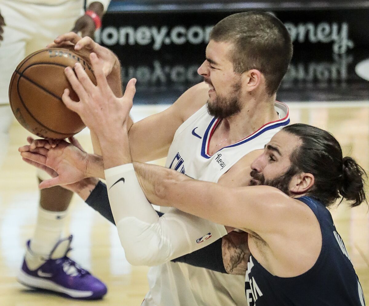 Clippers center Ivica Zubac is fouled by Timberwolves guard Ricky Rubio.