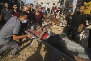 Palestinians pull a boy from the rubble after an Israeli strike on the Zaroub family house in Rafah, Gaza Strip, Tuesday, Oct.24, 2023. (AP Photo/Hatem Ali)