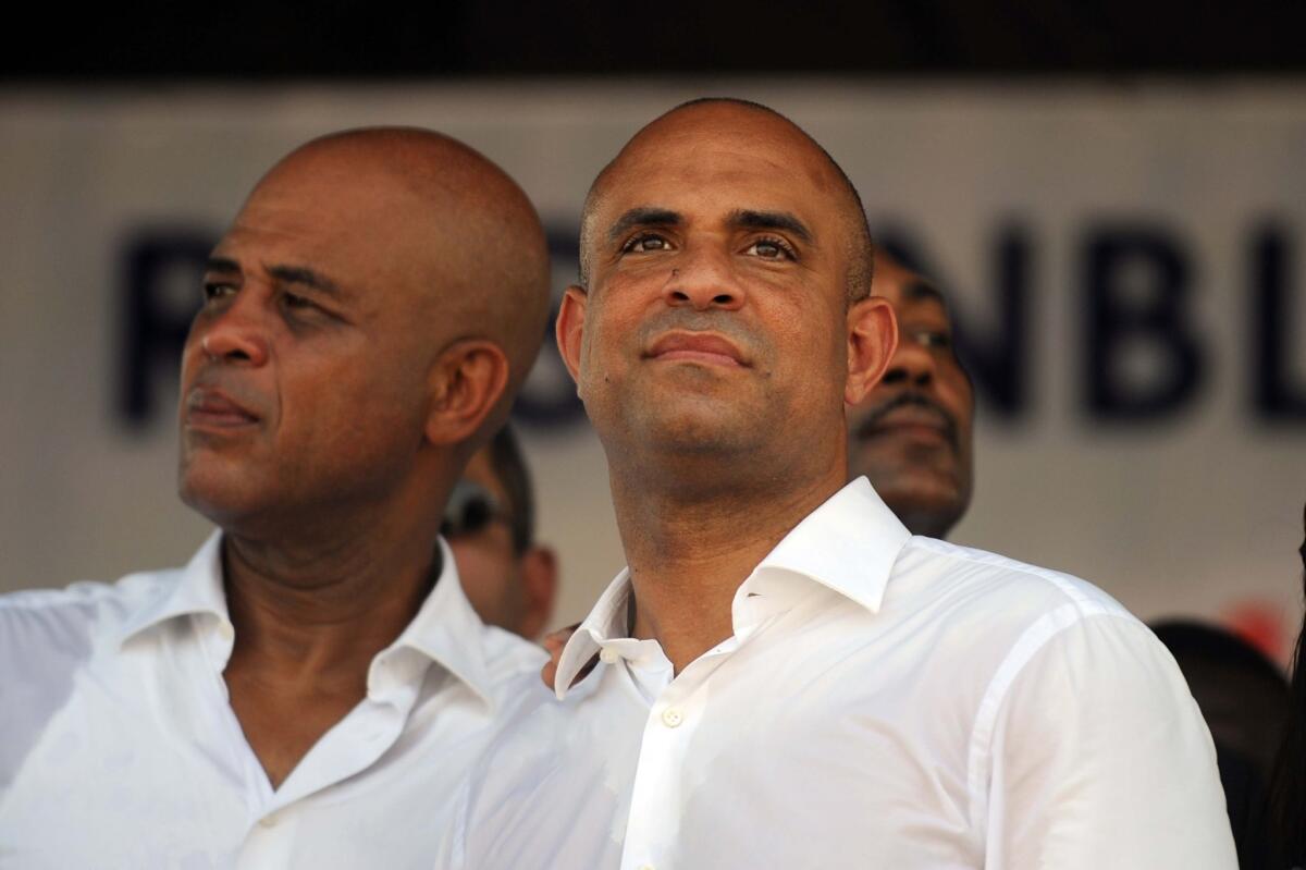 Haitian President Michel Martelly, left, and Prime Minister Laurent Lamothe at an event in Port-au-Prince, Haiti, in October. Lamothe announced his resignation Sunday.