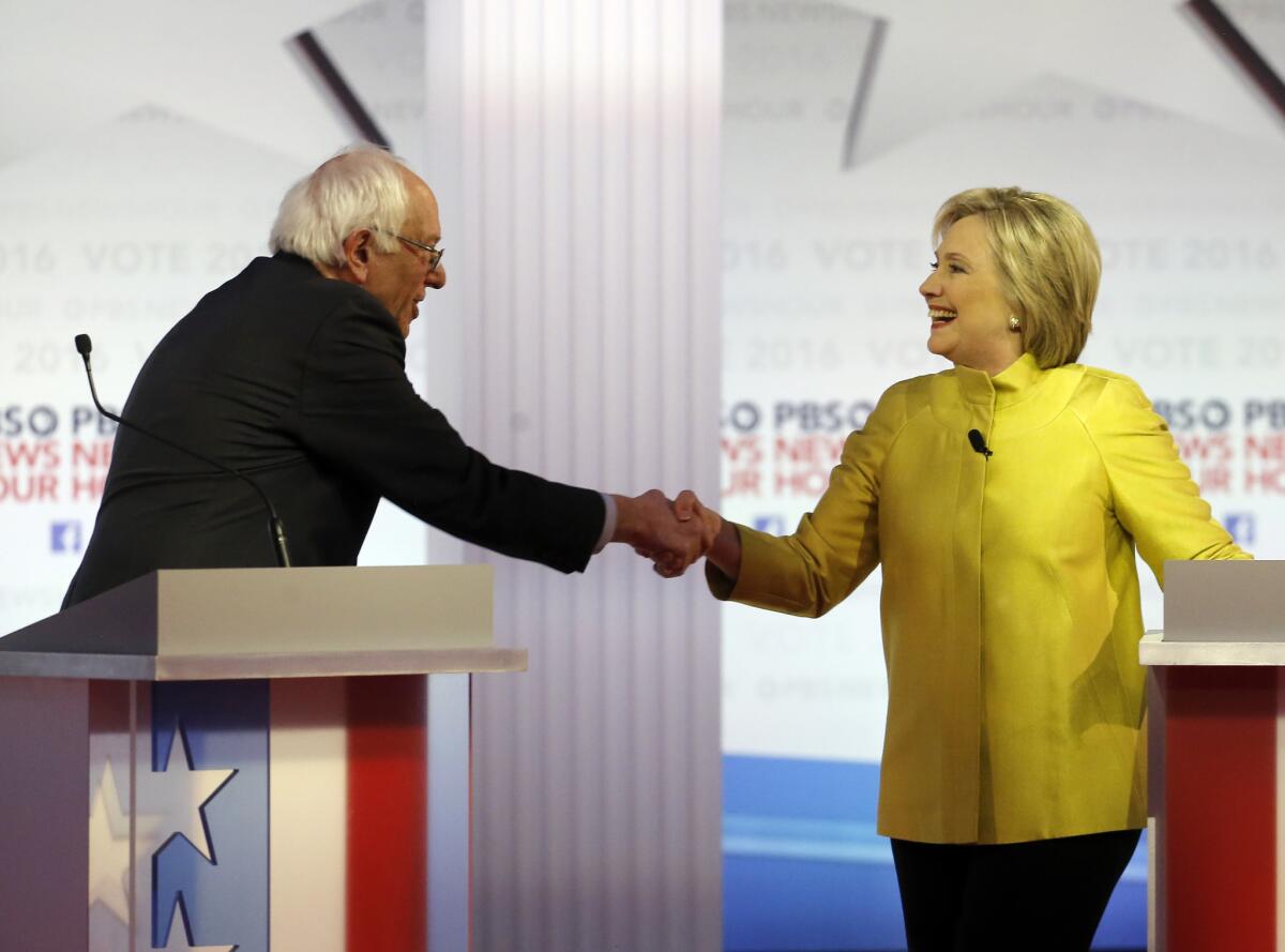 Democratic presidential candidates Bernie Sanders and Hillary Clinton shake hands after a debate at the University of Wisconsin-Milwaukee on Thursday.