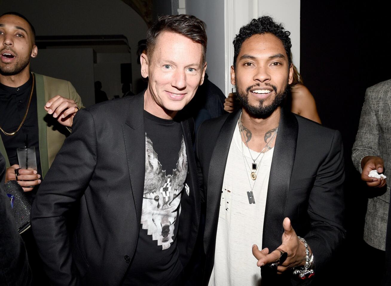 GQ Editor in Chief Jim Nelson and recording artist Miguel attend the GQ and Giorgio Armani Grammys after-party at Hollywood Athletic Club.
