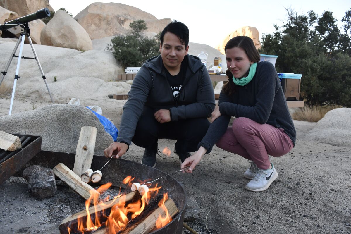 Campers Edgar Carrillo and Holly Hirschi roast marshmallows May 20 at Hidden Valley campground in Joshua Tree National Park.