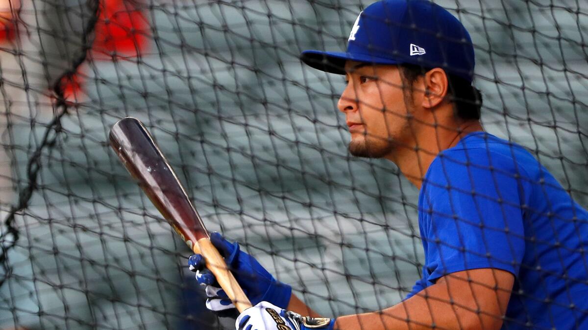 New Dodgers pitcher Yu Darvish practices bunting, something he did not have to do in the American League, before a game Wednesday.