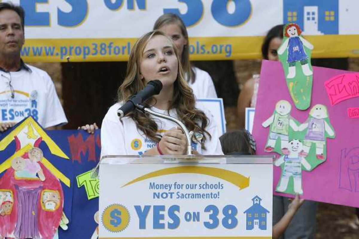 Crescenta Valley High School student Joy McCreary speaks to a small group of supporters where Glendale PTA members gathered at Verdugo Park to show their support for Proposition 38.