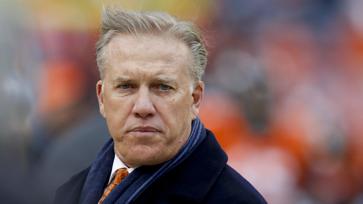 John Elway, Denver Broncos executive vice president and general manager, watches from the sideline during the team's playoff loss to the Indianapolis Colts on Sunday.