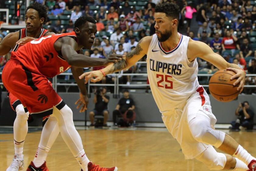 Los Angeles Clippers guard Austin Rivers (25) drives the ball past Toronto Raptors forward Pascal Siakam (43) during the first quarter of a preseason NBA basketball game, Sunday, Oct. 1, 2017, in Honolulu. (AP Photo/Marco Garcia)