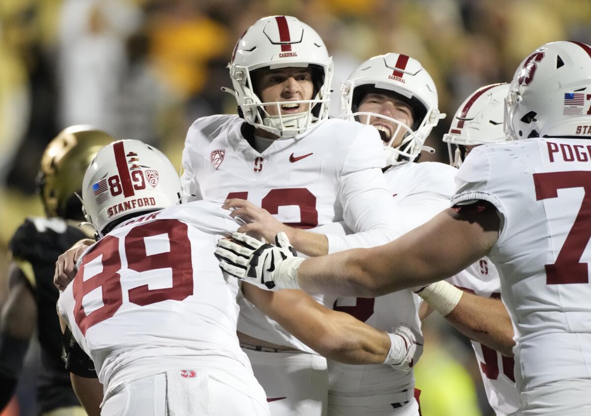 Stanford's Joshua Karty, center, celebrates with teammates after kicking the winning field goal.