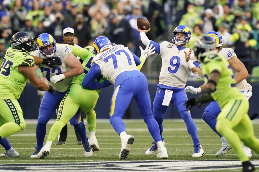 Rams quarterback Matthew Stafford (9) passes under pressure from the Seahawks defense.