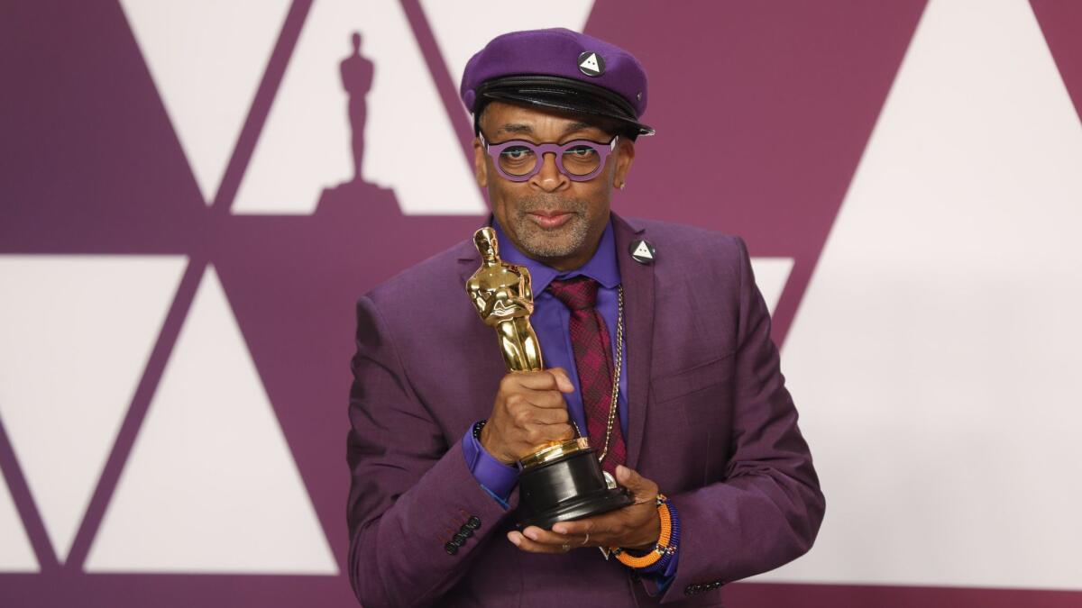 Spike Lee holds his Oscar for adapted screenplay for "BlacKkKlansman."