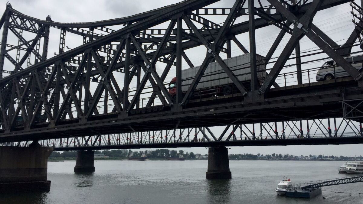 Trucks cross the Sino-Korean Friendship Bridge from North Korea into Dandong, China.
