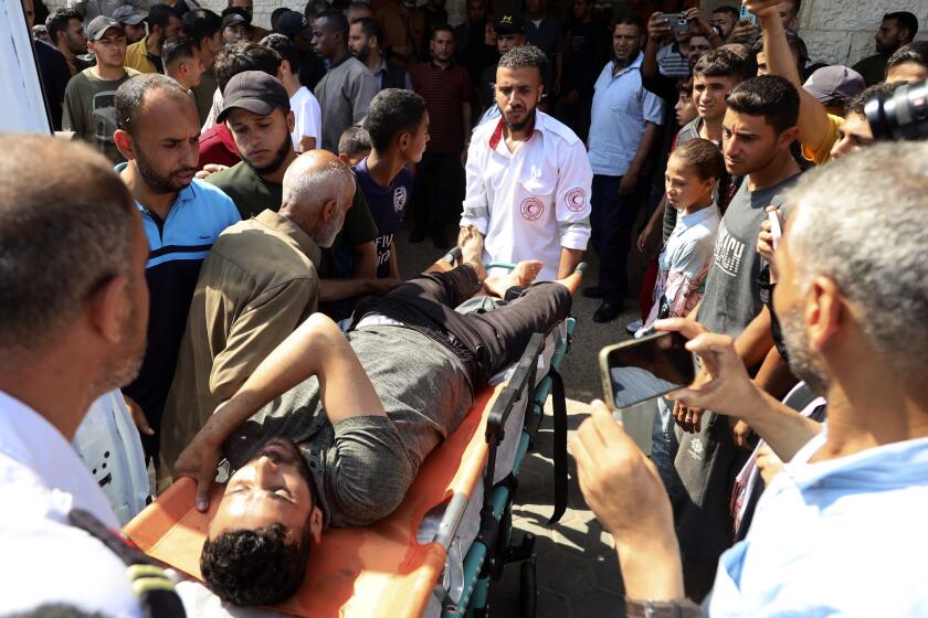 Palestinian wounded in an Israeli airstrike on a vehicle is brought to at al-Aqsa Martyrs hospital in Deir al Balah, central Gaza Strip, Tuesday, June 4, 2024. (AP Photo/Saher Alghorra)