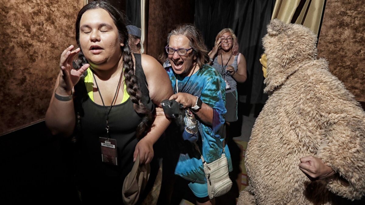 An actor dressed as a bear startles visitors of the Shining maze at Halloween Horror Nights at Universal Studios.
