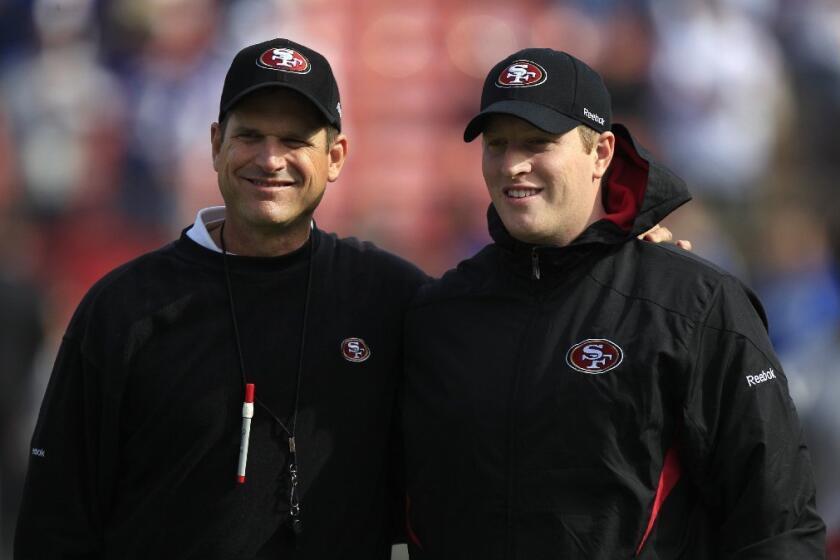 San Francisco 49ers head coach Jim Harbaugh, left, and his son Jay are shown before an NFL football game against the New York Giants in 2011.