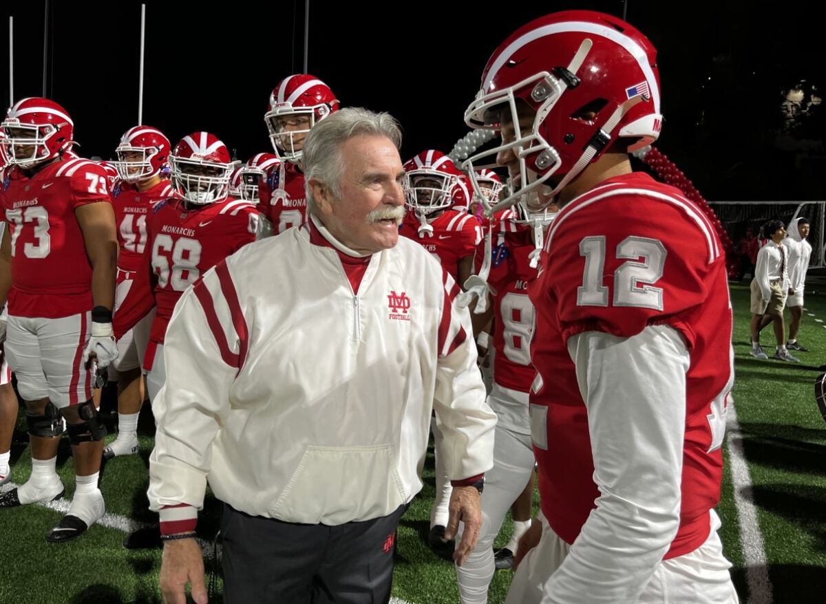 Mater Dei coach Bruce Rollinson speaks to quarterback Elijah Brown.